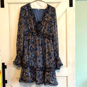 Long sleeved blue dress with ruffle detailing.